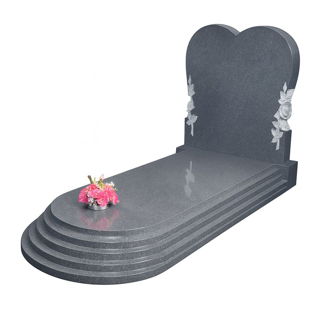 A heart-shaped headstone with floral details and a rounded stepped cover.