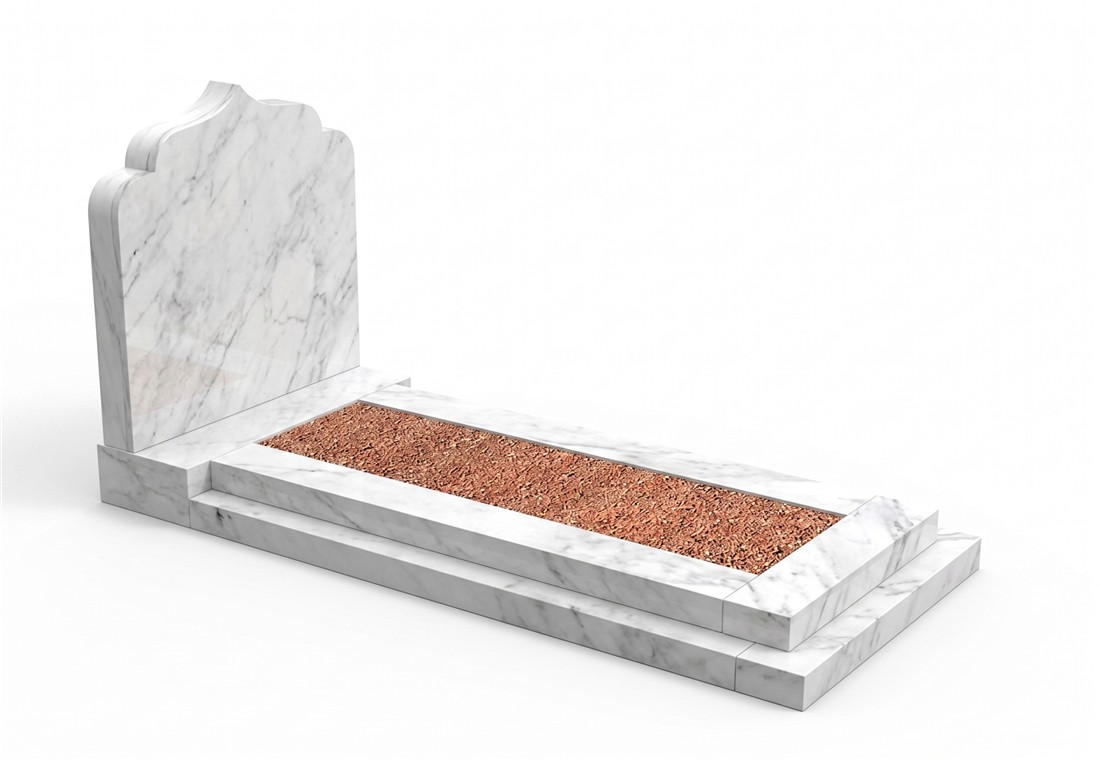 A pale veined headstone and kerbed surround with warm-toned chippings.