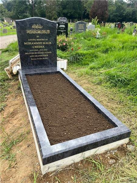 Dark headstone with contrasting pale kerbs