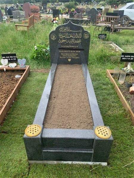 Dark memorial with gold-toned details