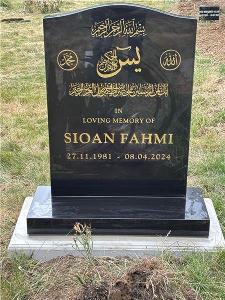 Dark headstone with gold inscription