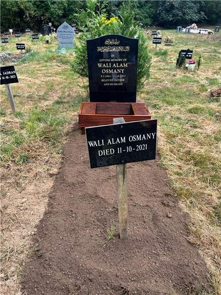 Dark headstone at a graveside