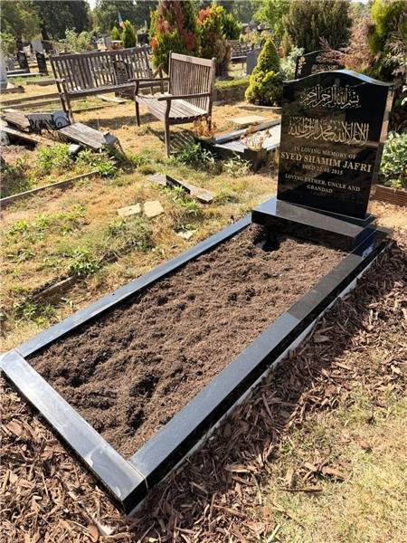 Dark headstone with pale surround