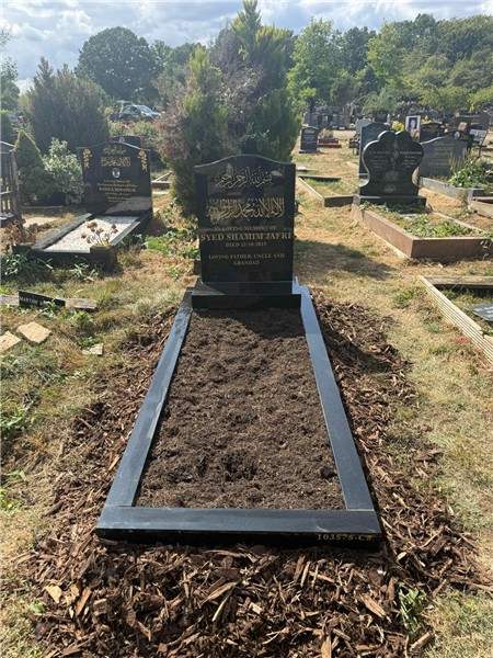 Dark headstone with open surround