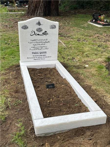 White headstone with kerbed surround